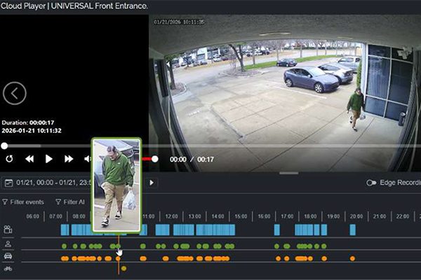 Image of a vido player with a man walking into the building from the parking lot